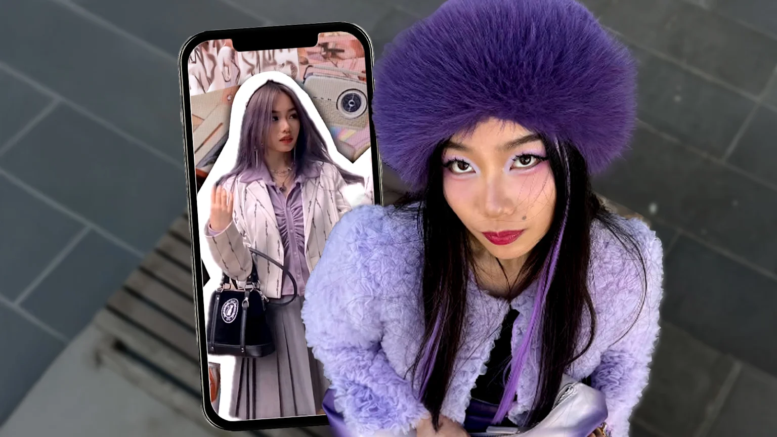 A woman in a purple fuzzy hat, fluffy purple jacket, and bold purple eye makeup looks at the camera, while a smartphone to the left shows a photo of a woman with light purple hair in a blazer.