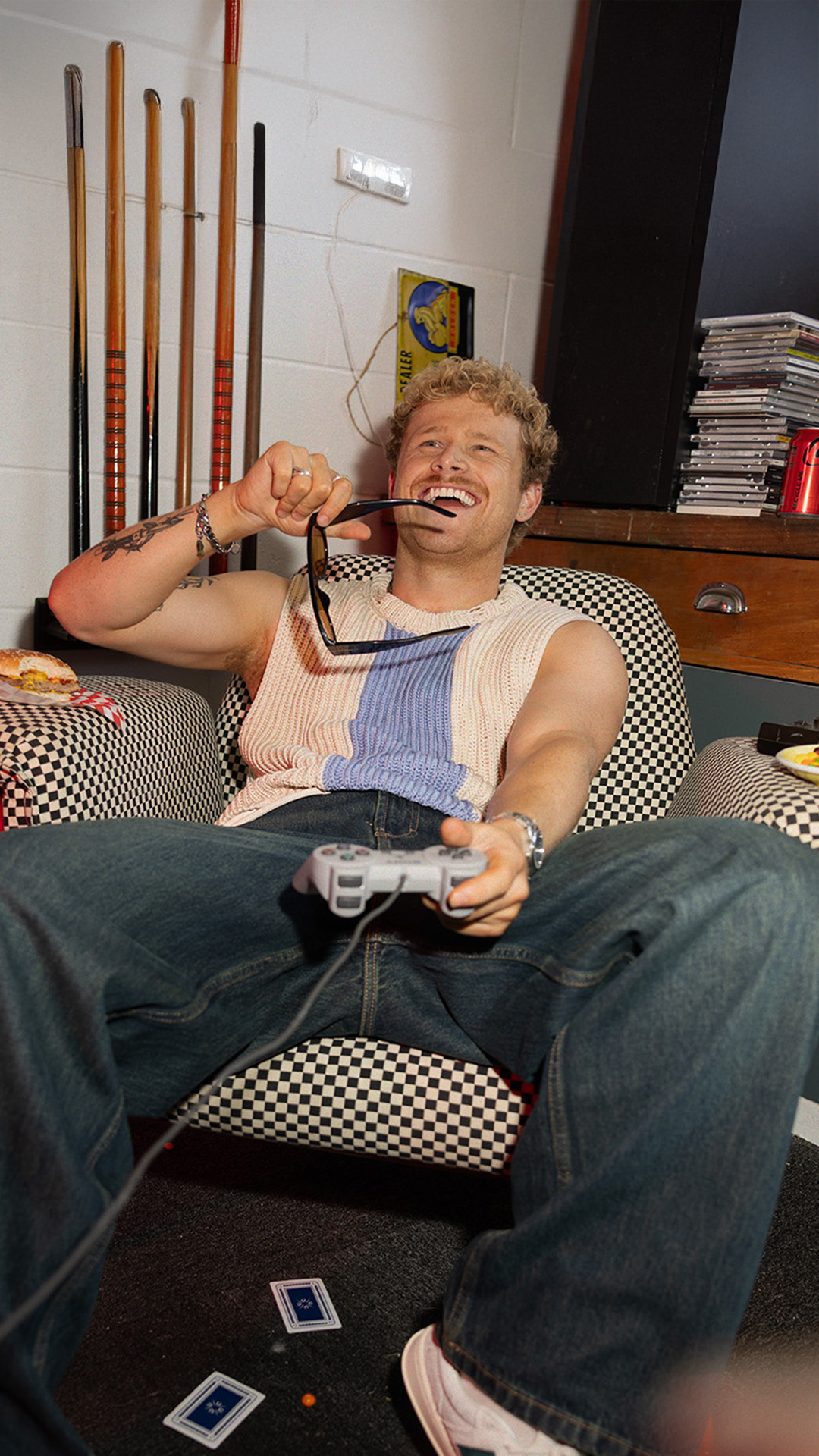 Person playing video games with burger