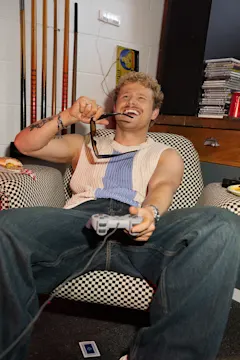 Person playing video games with burger