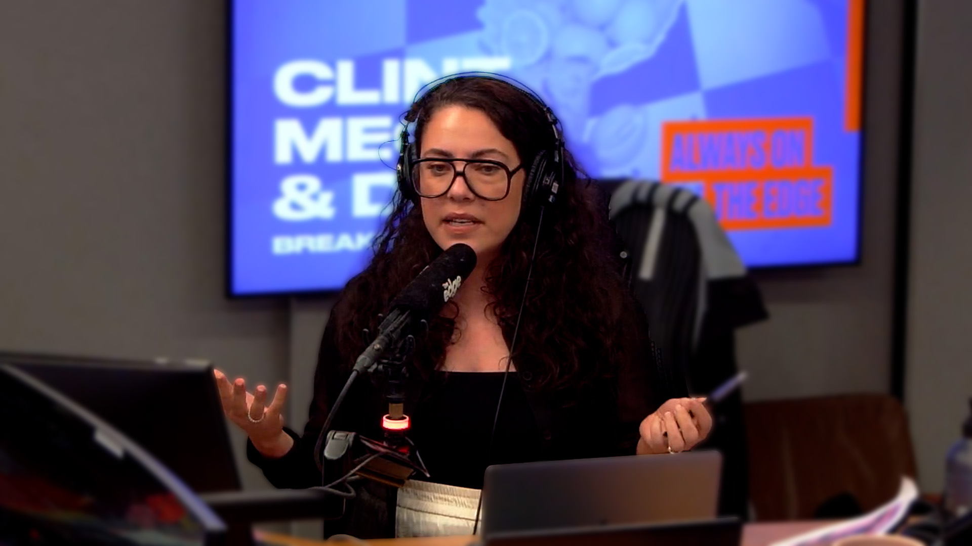 Ash London talking into a microphone