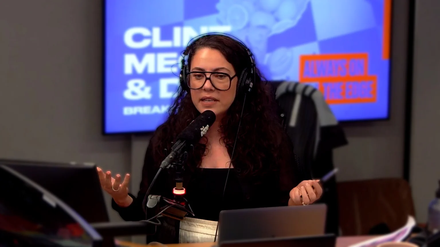 Ash London talking into a microphone