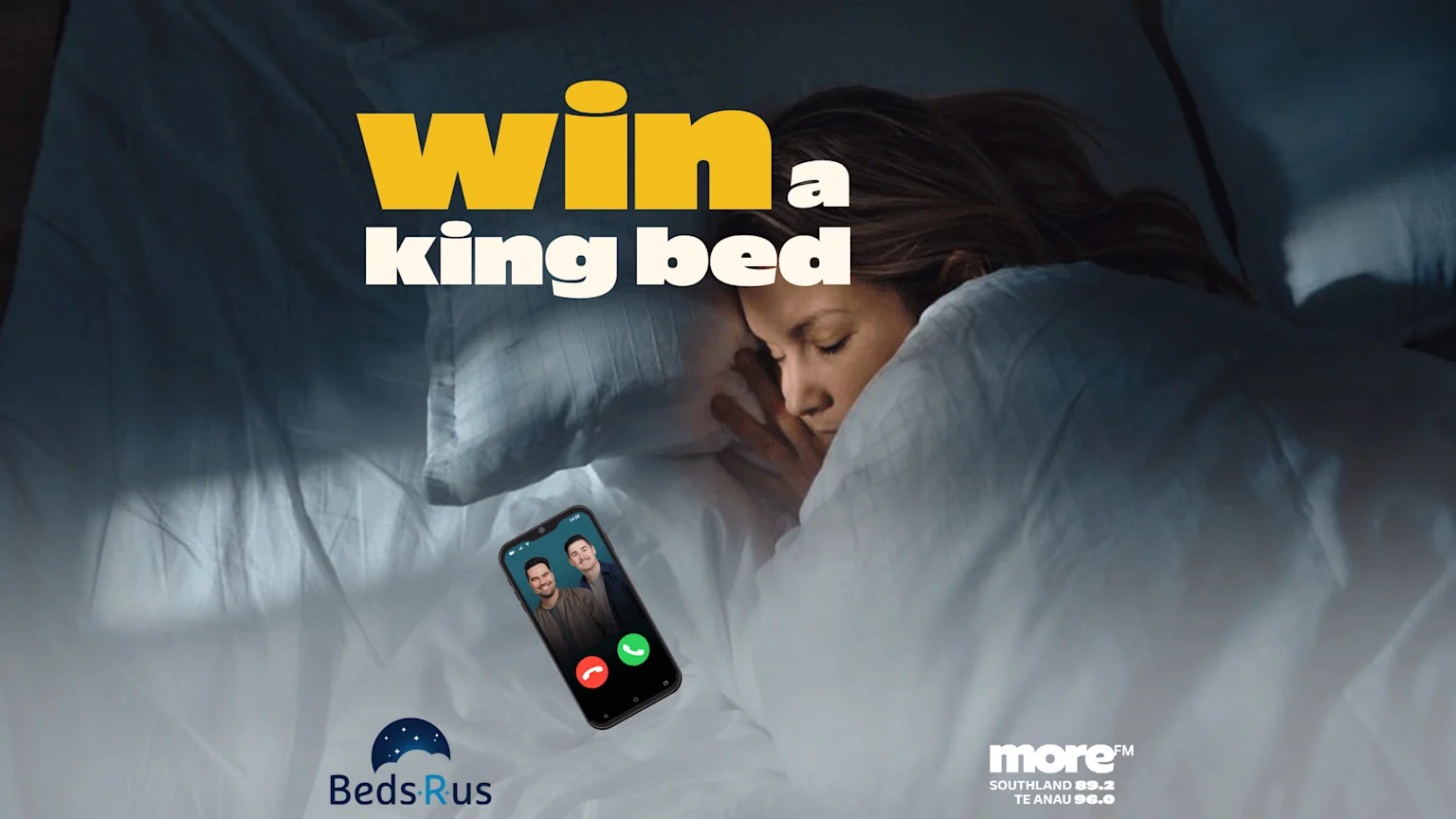 A woman sleeps in a bed with white sheets, next to a smartphone showing a video call; text says 'win a king bed' and logos for Beds R Us and more FM are visible.