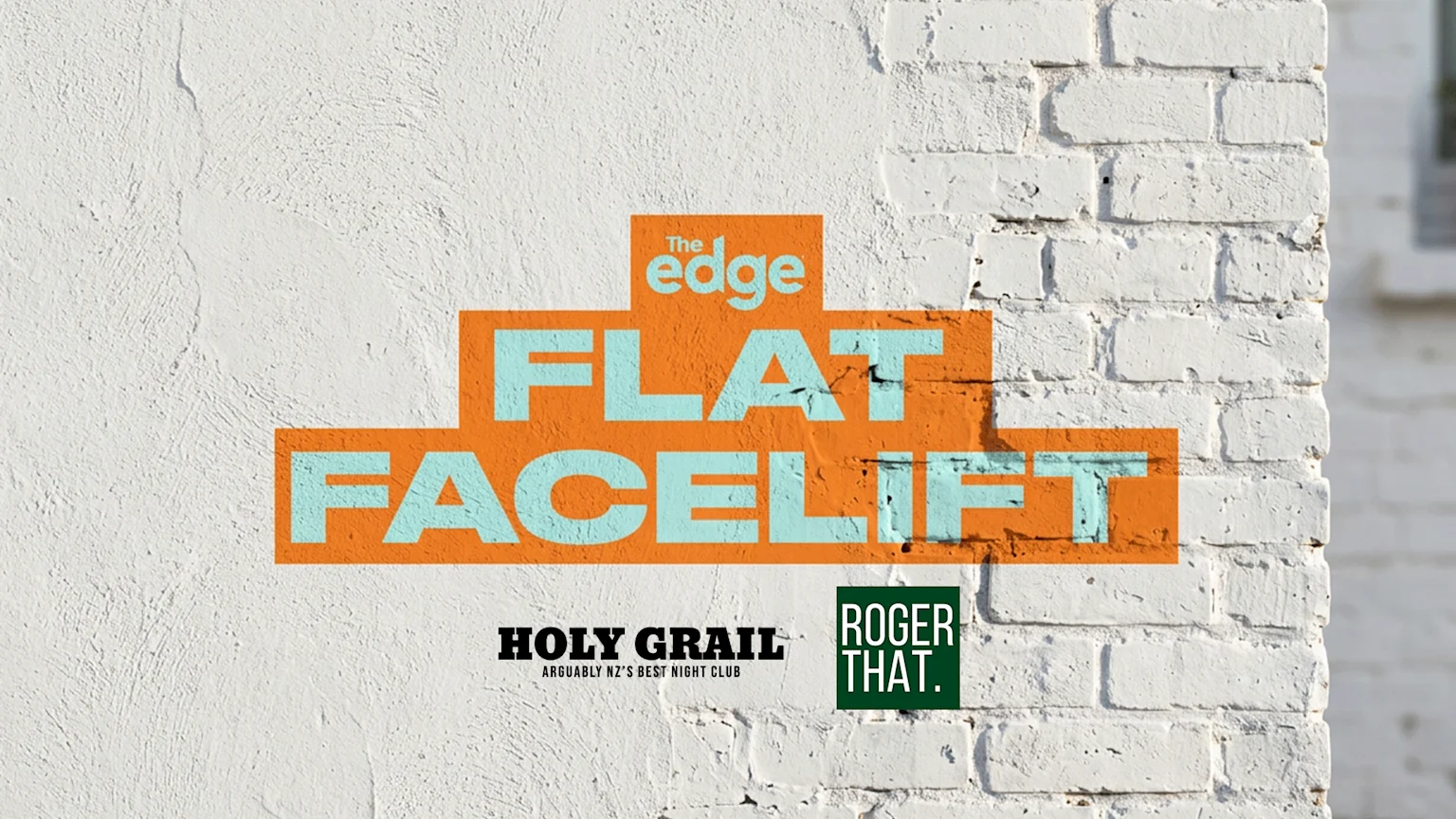 A graphic on a white textured and brick wall features orange rectangles with light blue text reading "The edge FLAT FACELIFT", with "HOLY GRAIL" and "ROGER THAT." logos below.
