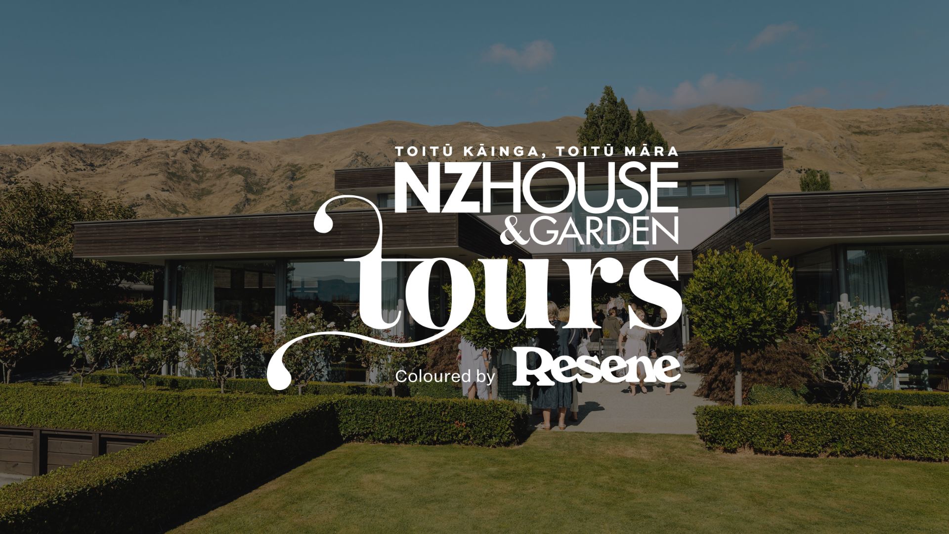 A modern house with a manicured garden and distant hills, overlaid with white text 'TOITŪ KĀINGA, TOITŪ MĀRA NZ HOUSE & GARDEN tours' and 'Coloured by Resene'.