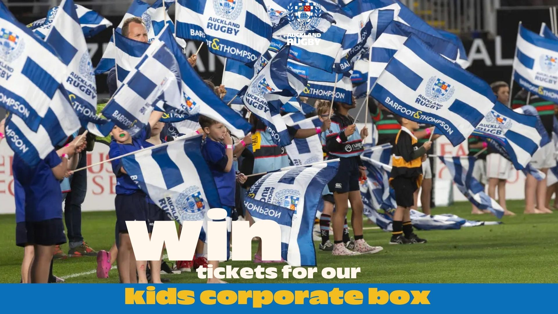 Children and adults wave blue and white Auckland Rugby flags on a sports field, with text overlay "Win tickets for our kids corporate box."
