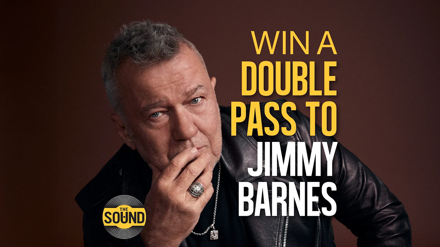 A thoughtful Jimmy Barnes, wearing a black leather jacket, looks at the viewer with his hand on his chin, alongside text that reads "WIN A DOUBLE PASS TO JIMMY BARNES."