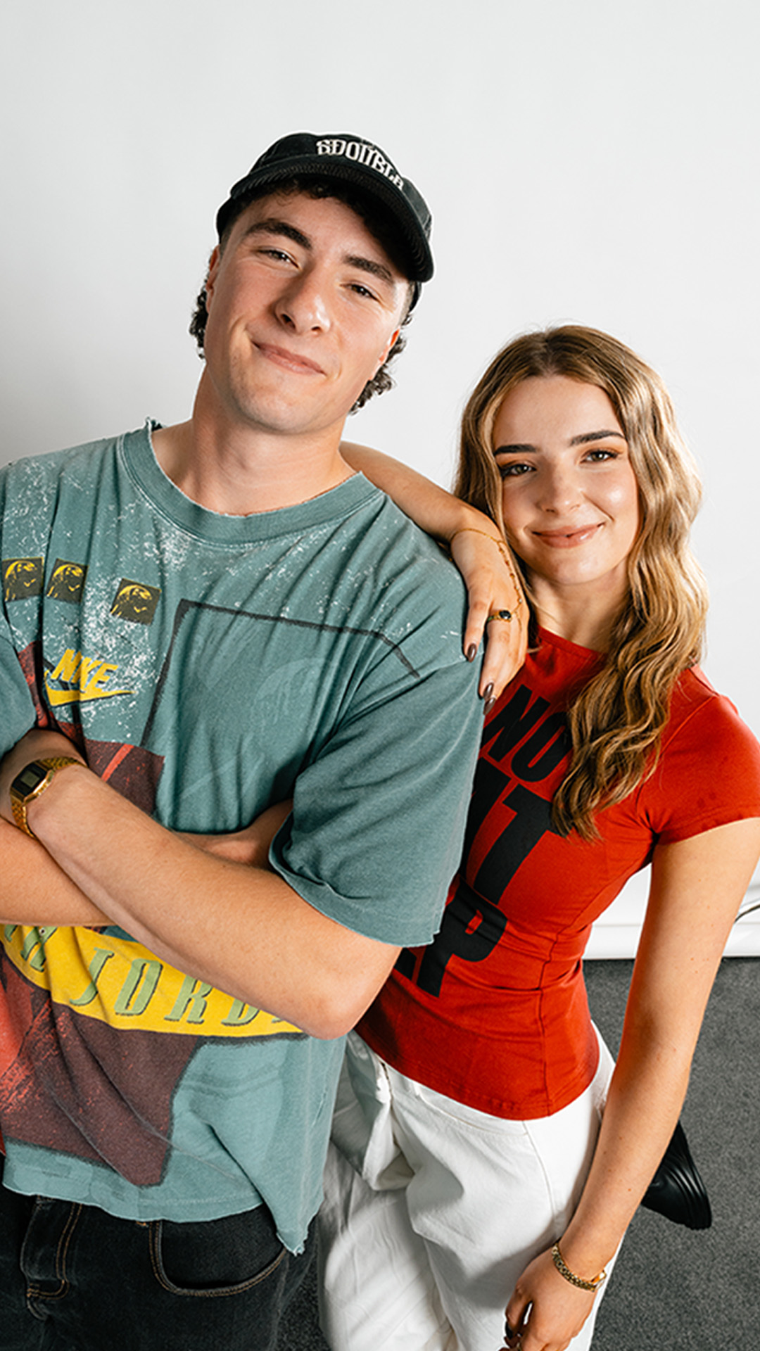 Two smiling people in casual clothing