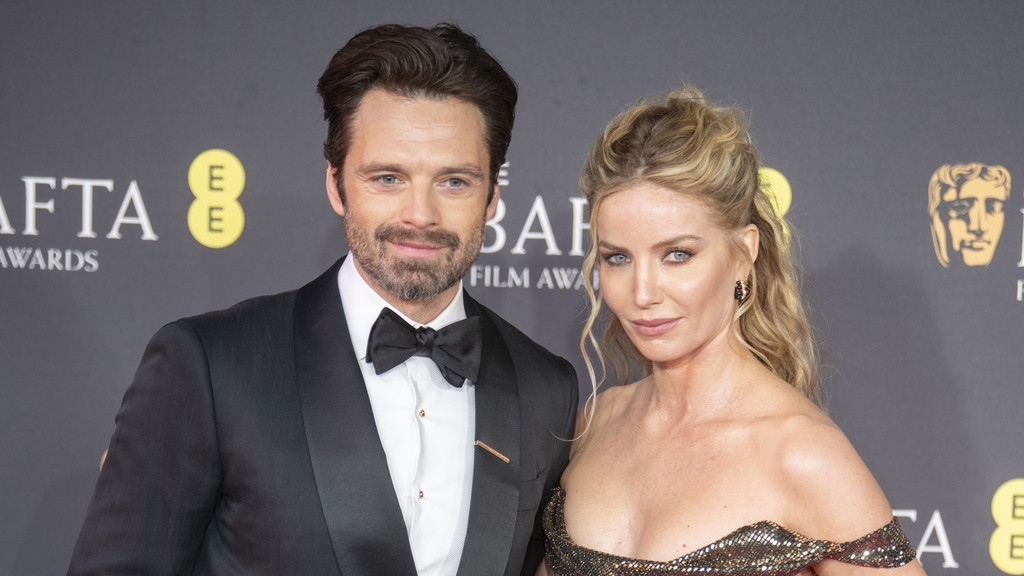 Sebastian Stan in a black tuxedo and Annabelle Wallis in a sparkling, off-the-shoulder gown pose together at a BAFTA Film Awards event.