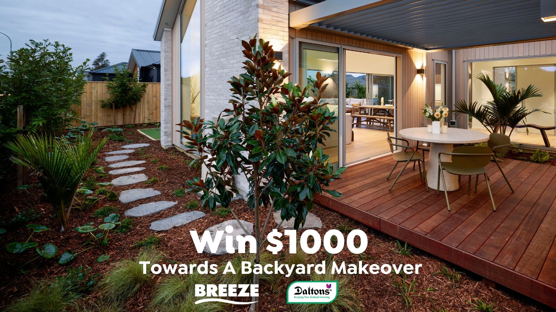 A modern house with a wooden deck, an outdoor dining set, and a landscaped garden with a stepping stone path and plants, promoting a backyard makeover contest.