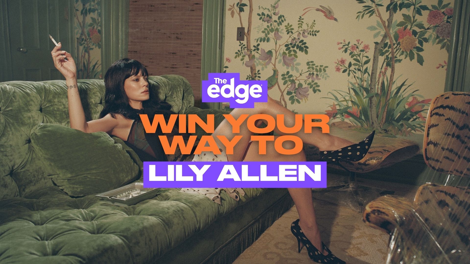Lily Allen reclines on a green velvet couch, holding a cigarette, wearing a dark top and polka dot heels, with "Win Your Way To Lily Allen" text overlay.