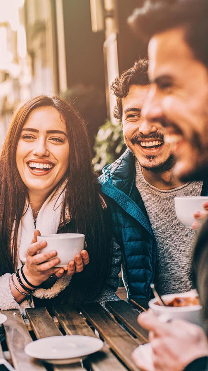 Friends laughing at outdoor café