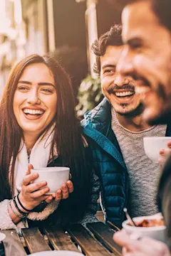 Friends laughing at outdoor café