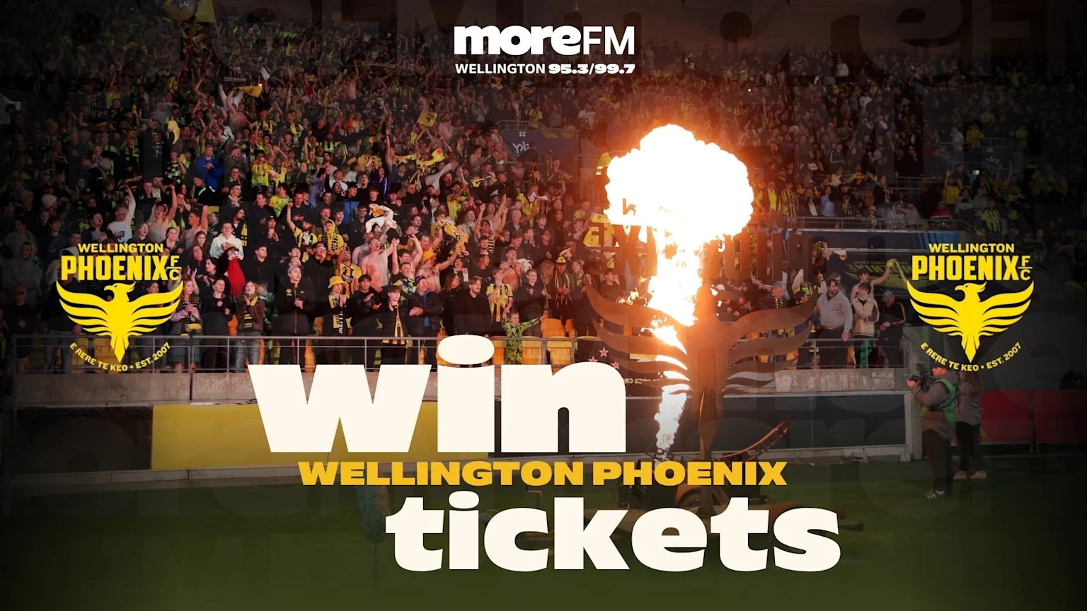 A stadium filled with cheering Wellington Phoenix FC fans in yellow and black, with the team's logo, a flaming sculpture, and "Win WELLINGTON PHOENIX tickets" text overlaid.