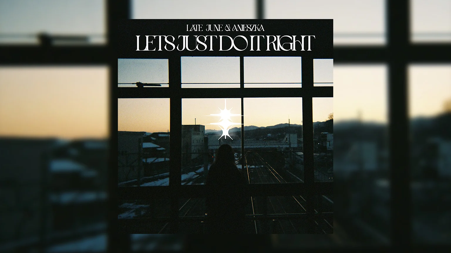 Album cover featuring a silhouetted figure gazing out a window at a sunset view with buildings, snow, and train tracks, adorned with white text "LATE JUNE & ANIESZKA LETS JUST DO IT RIGHT" and bright starburst graphics.