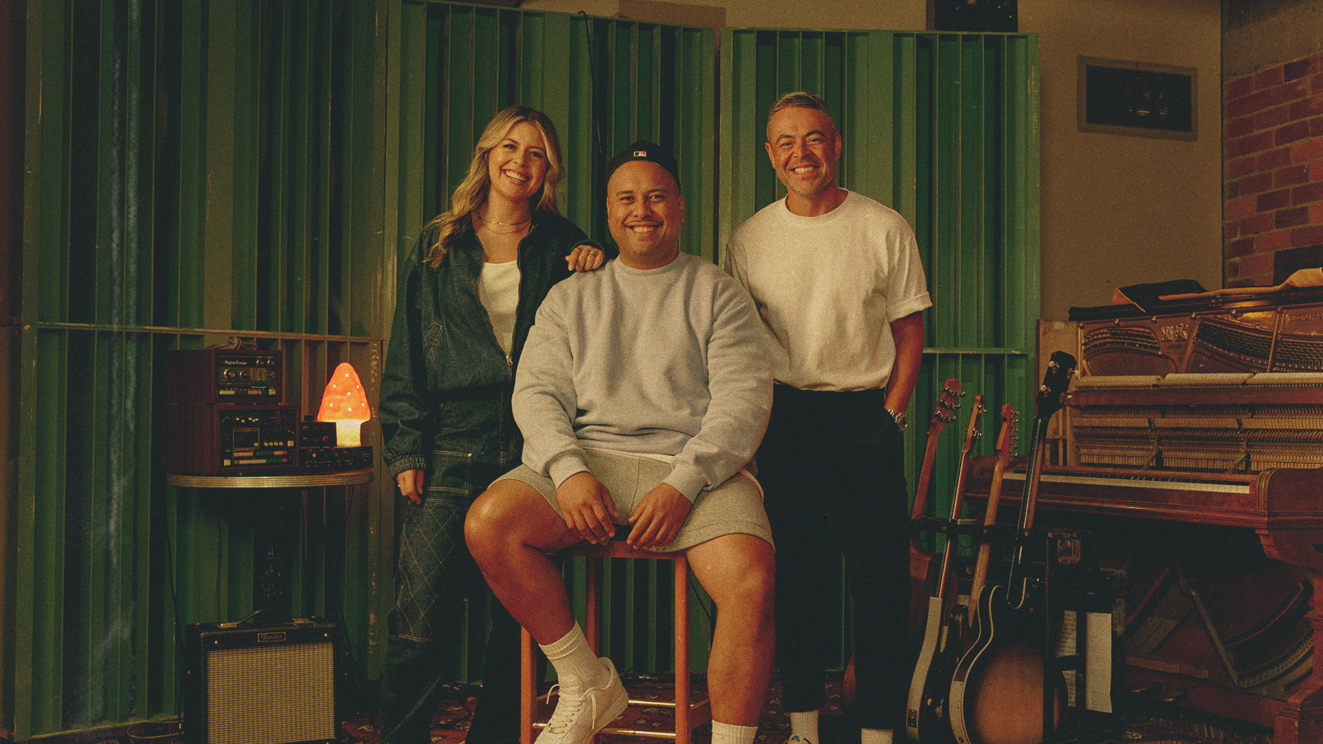 Tegan, Fame and Nickson smiling at a music studio