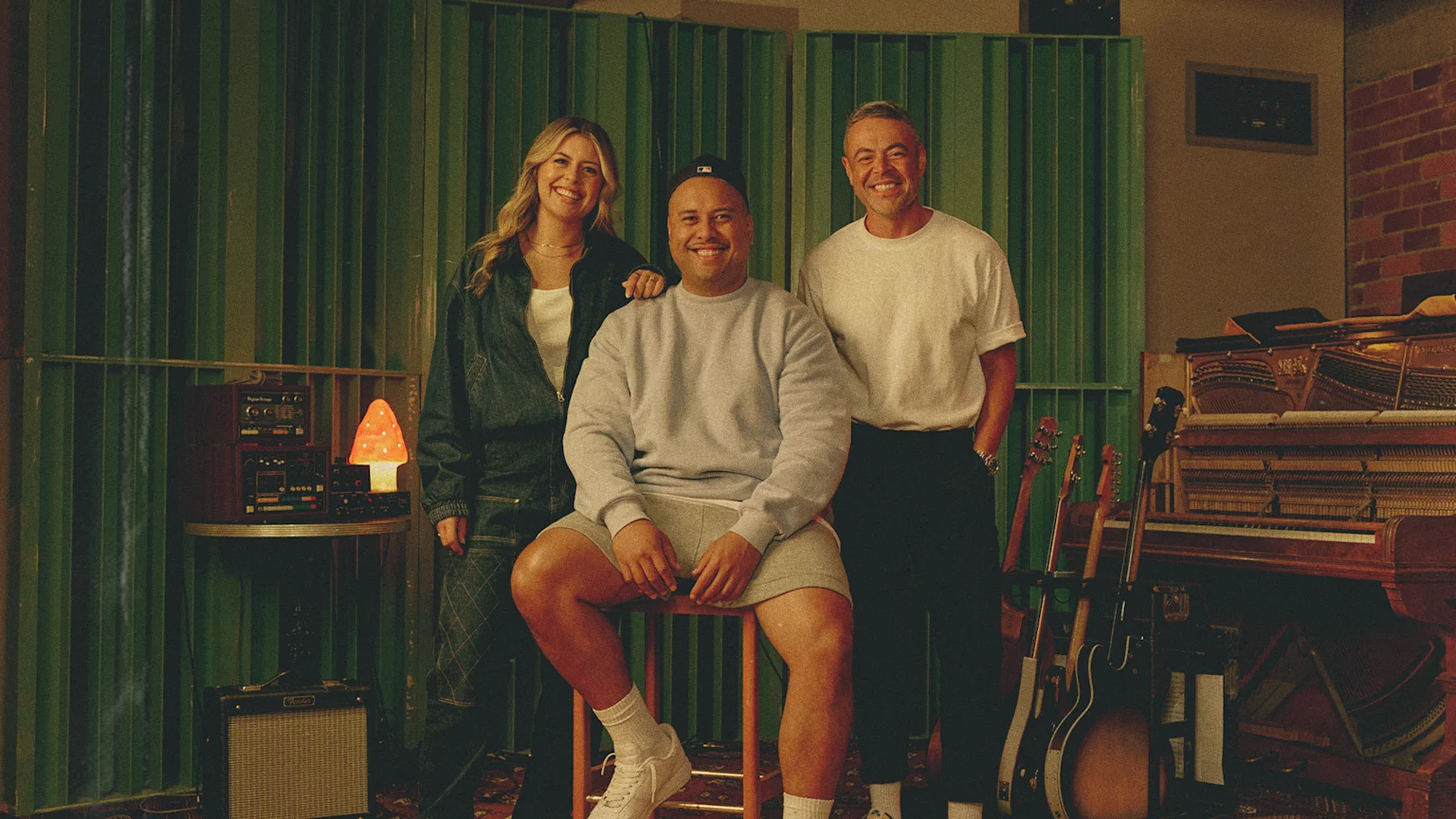 Tegan, Fame and Nickson smiling at a music studio
