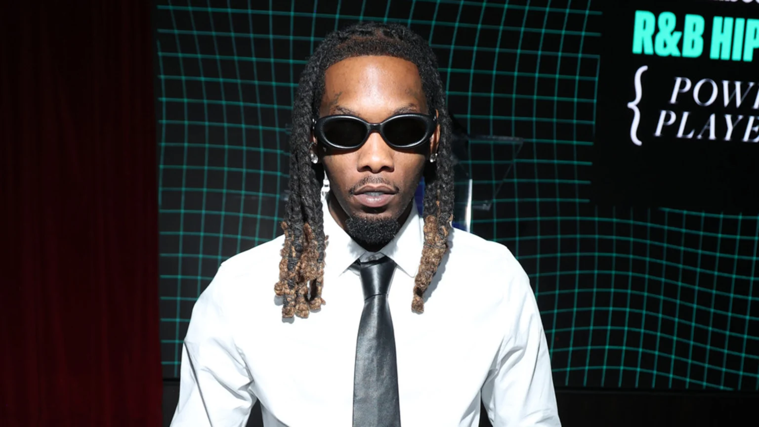 Offset with dreadlocks and beard, wearing sunglasses, a white shirt, and a black tie, stands against a teal grid background with "R&B HIP" and "POWER PLAYERS" text visible.