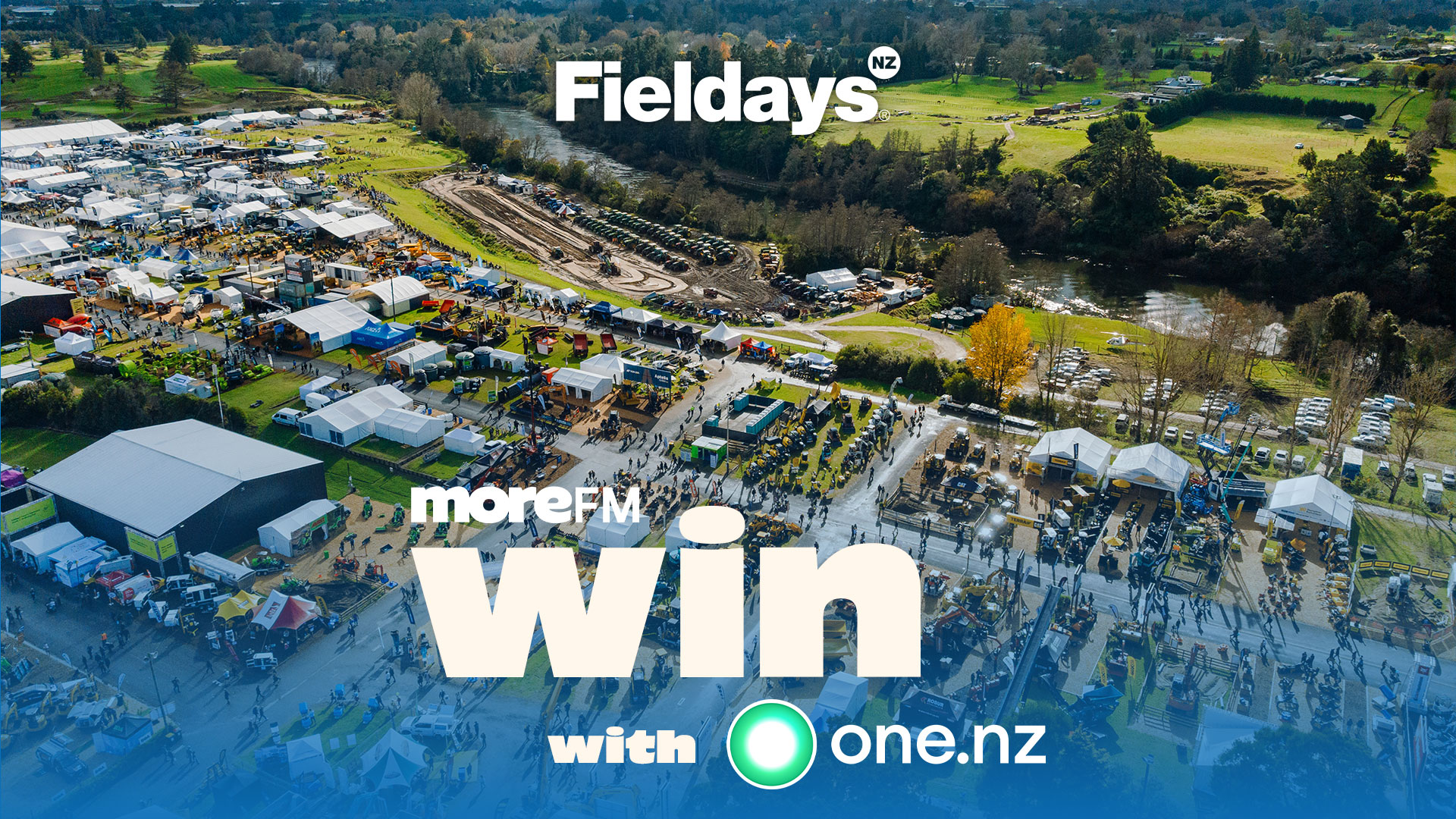 Aerial view of a large, busy Fieldays event with white tents, crowds, and machinery, featuring "Fieldays NZ" and "moreFM win with one.nz" text overlays.