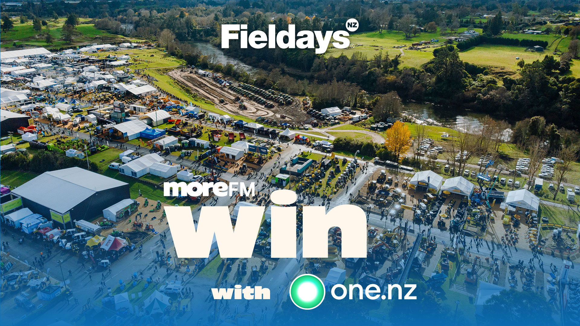 Aerial view of a large, busy Fieldays event with white tents, crowds, and machinery, featuring "Fieldays NZ" and "moreFM win with one.nz" text overlays.