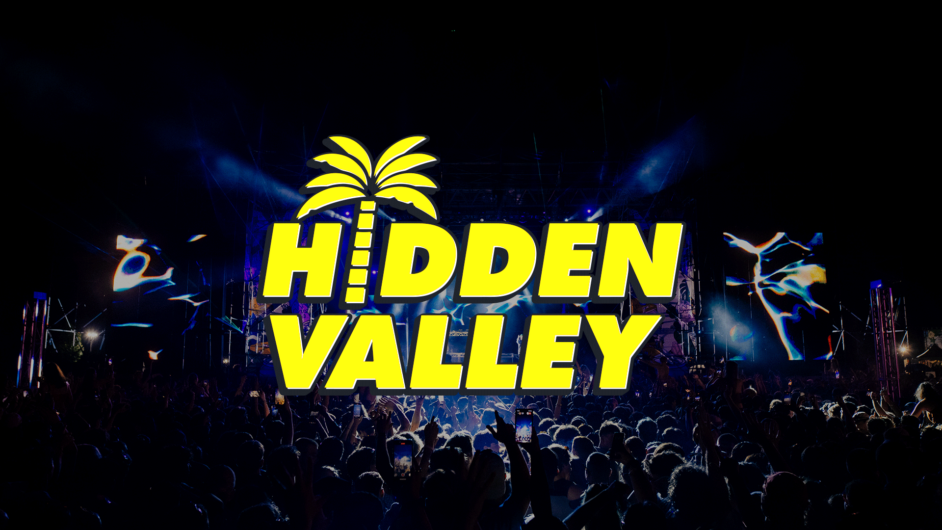 A large crowd attends a night concert with a brightly lit stage in the background, featuring a prominent yellow "HIDDEN VALLEY" logo with a palm tree icon.