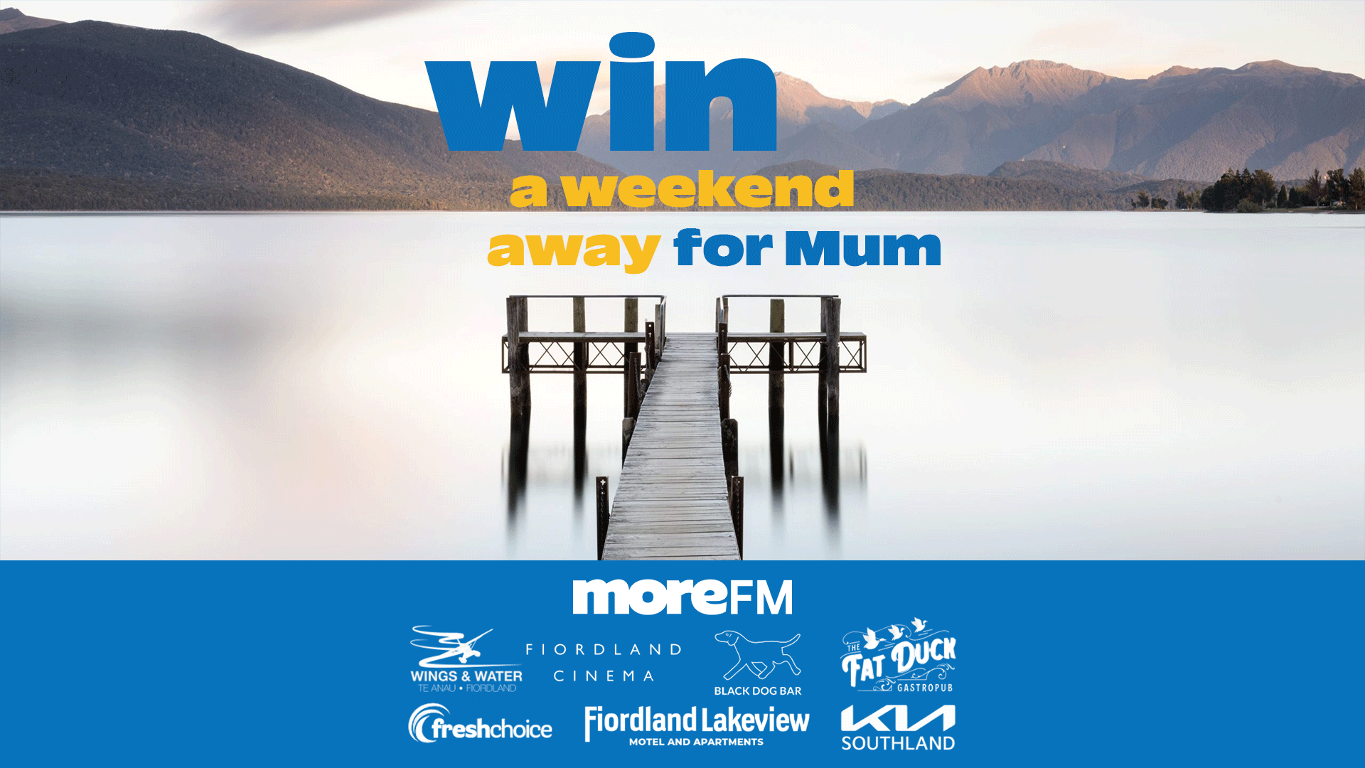 A serene lake and mountains with a pier, promoting "win a weekend away for Mum" above a blue banner with "moreFM" and Fiordland partner logos.