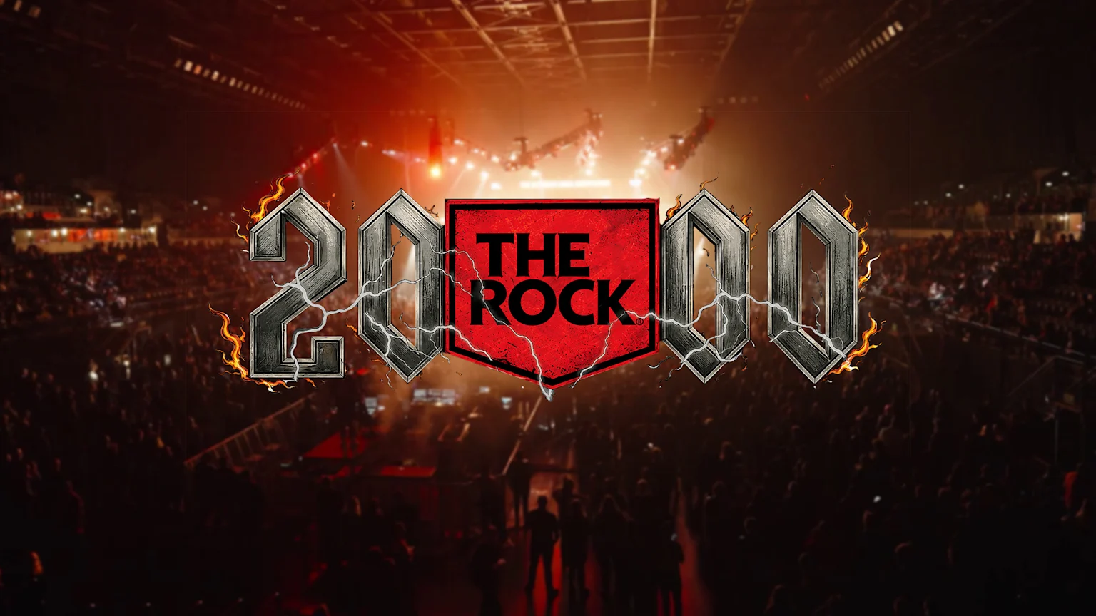 A fiery and metallic "2000" logo with "THE ROCK" in a red shield, overlaid on a dark, crowded concert hall with a glowing stage.