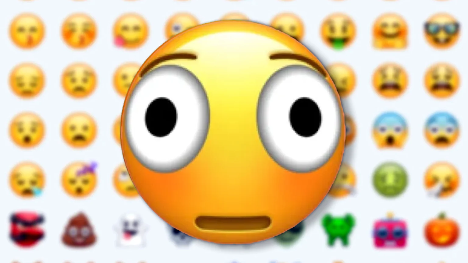A large, yellow, wide-eyed emoji with a surprised expression is prominent against a blurred background grid of numerous other diverse emojis.