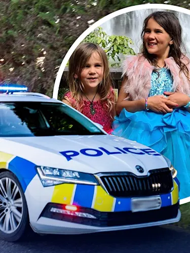 A NZ police care layered in front of fugitive Tom Phillips' three children.