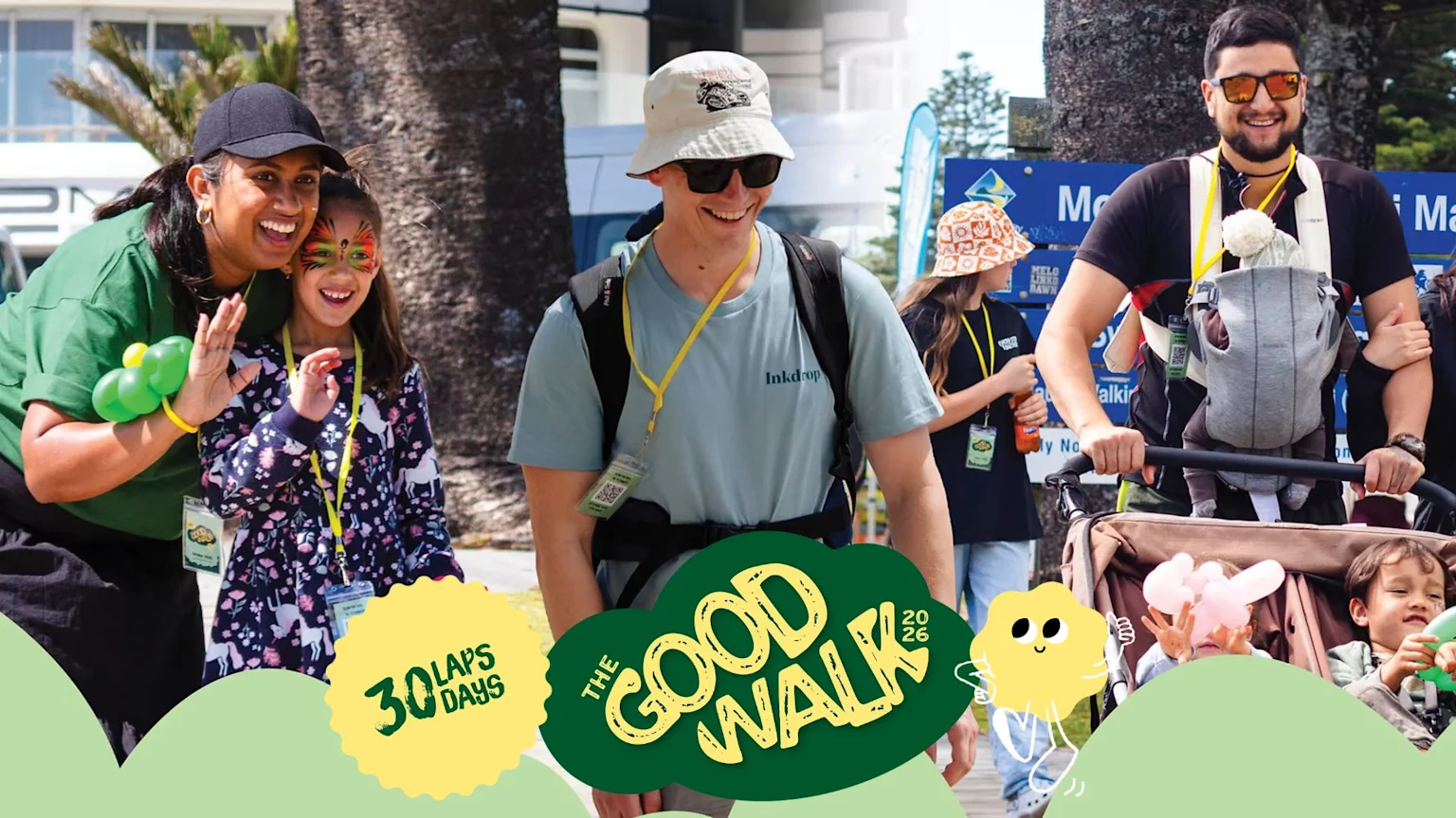 Happy participants of The Good Walk 2026, including adults and children with face paint and in strollers, walk outdoors on a sunny day.