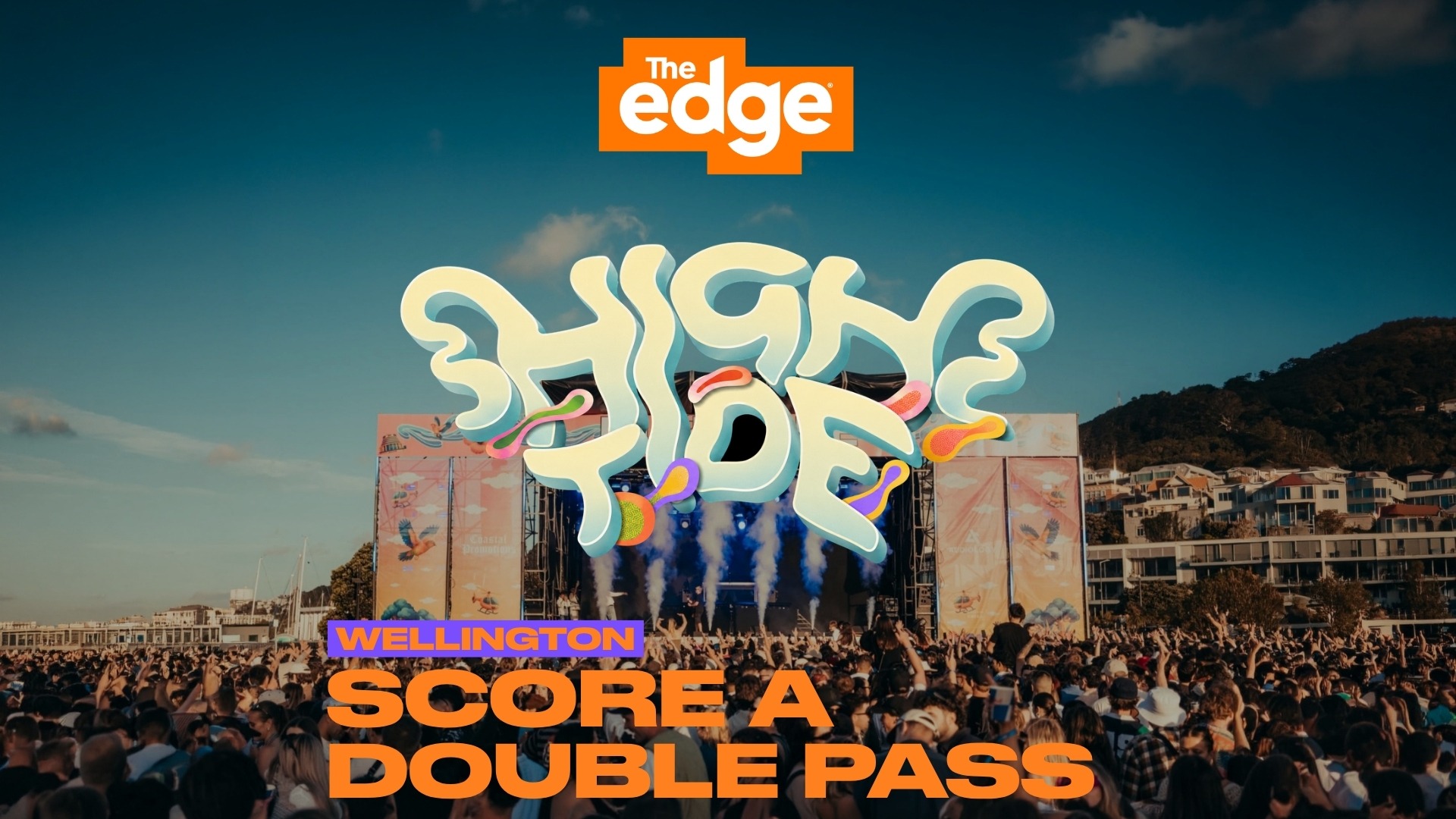 A vibrant outdoor music festival scene with a large crowd, a stage, and prominent overlays: 'The Edge', 'HIGH TIDE', and 'WELLINGTON SCORE A DOUBLE PASS'.