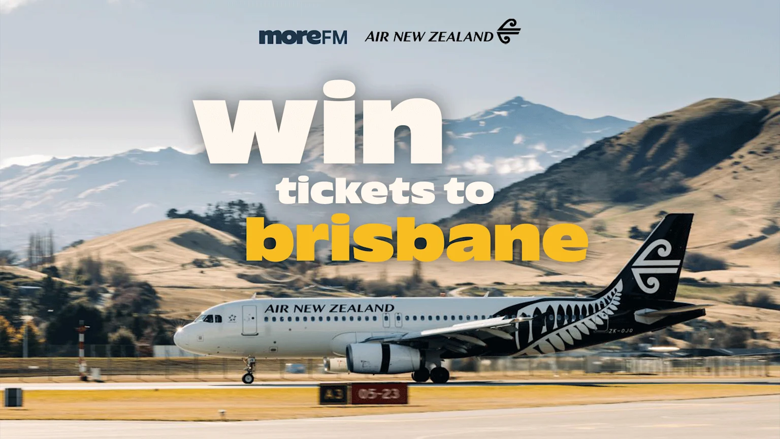 An Air New Zealand plane on a runway with mountains in the background, promoting a contest to "WIN tickets to brisbane" from More FM and Air New Zealand.