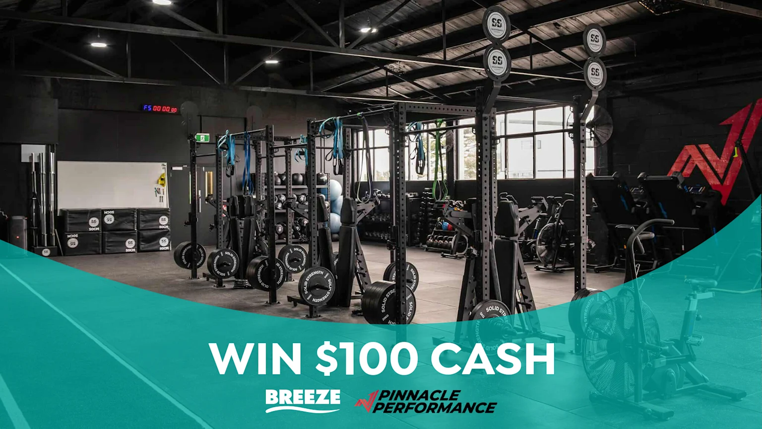 Modern gym with weight racks and equipment. "Win $100 Cash" with the Breeze and Pinnacle Performance.