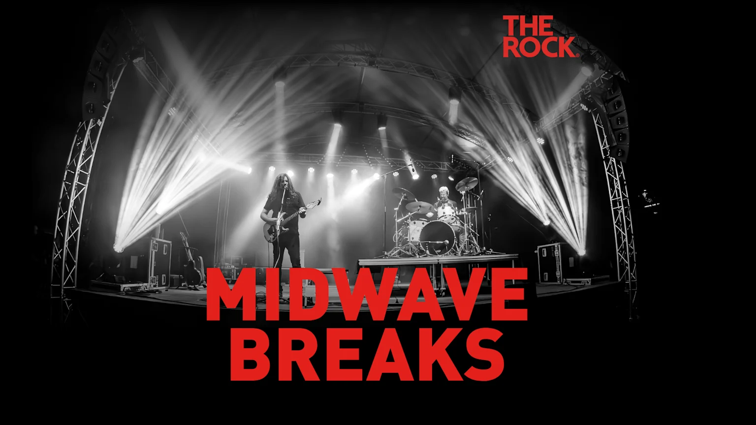 A black and white photo shows a two-person band, a guitarist and a drummer, performing on a brightly lit stage, with "MIDWAVE BREAKS" in large red letters at the bottom and "THE ROCK" logo in the top right.