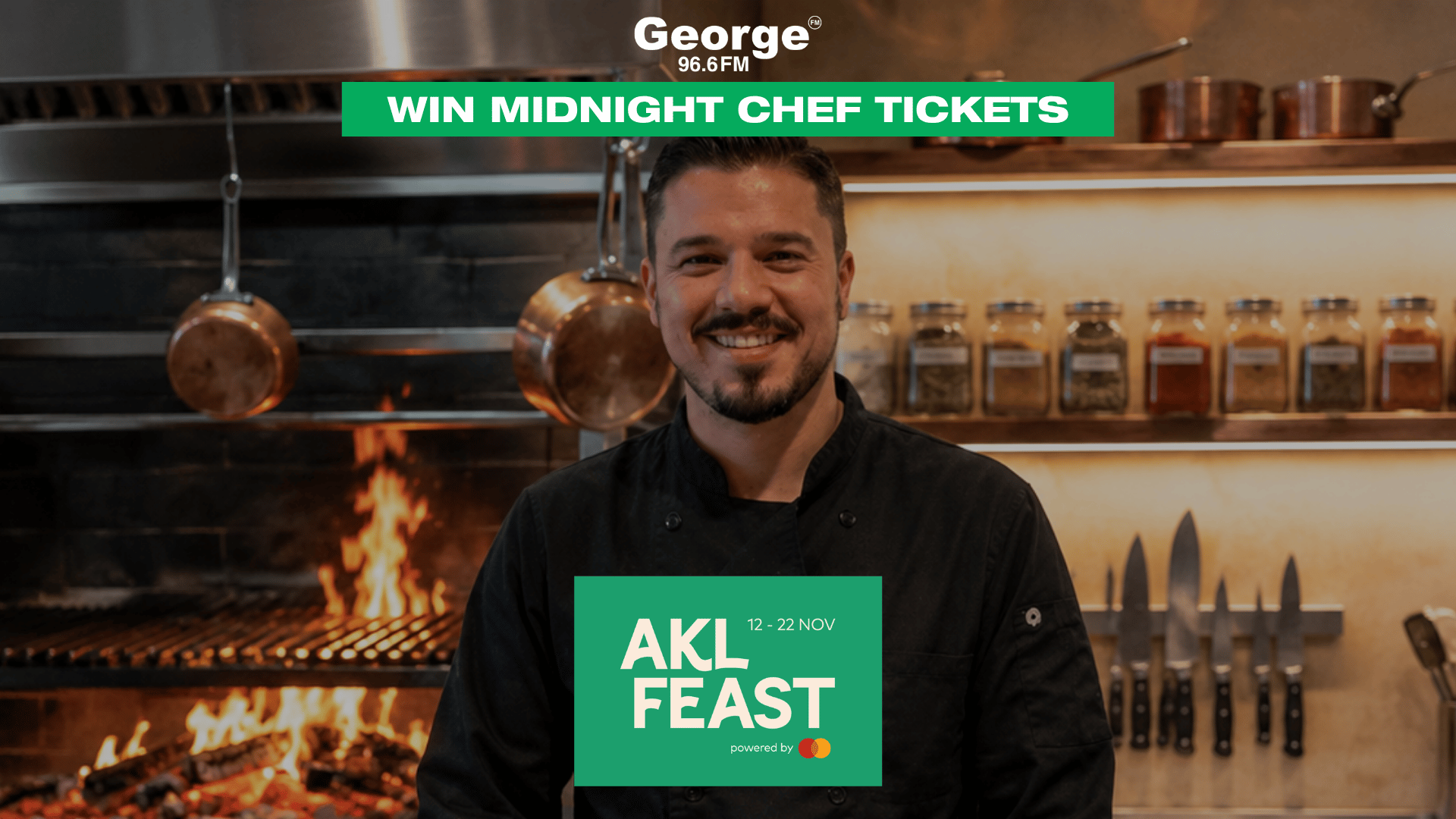 A smiling male chef in a black jacket is in a kitchen with a grill and flames, promoting "WIN MIDNIGHT CHEF TICKETS" by George 96.6FM and "AKL FEAST 12 - 22 NOV powered by Mastercard."