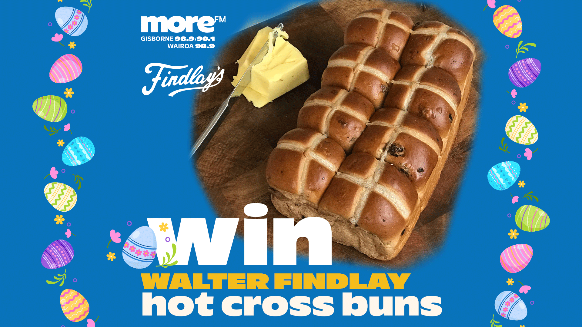 A blue background with Easter egg borders displays a loaf of Walter Findlay hot cross buns and butter on a wooden board, with text promoting a "Win Walter Findlay hot cross buns" contest from more FM.