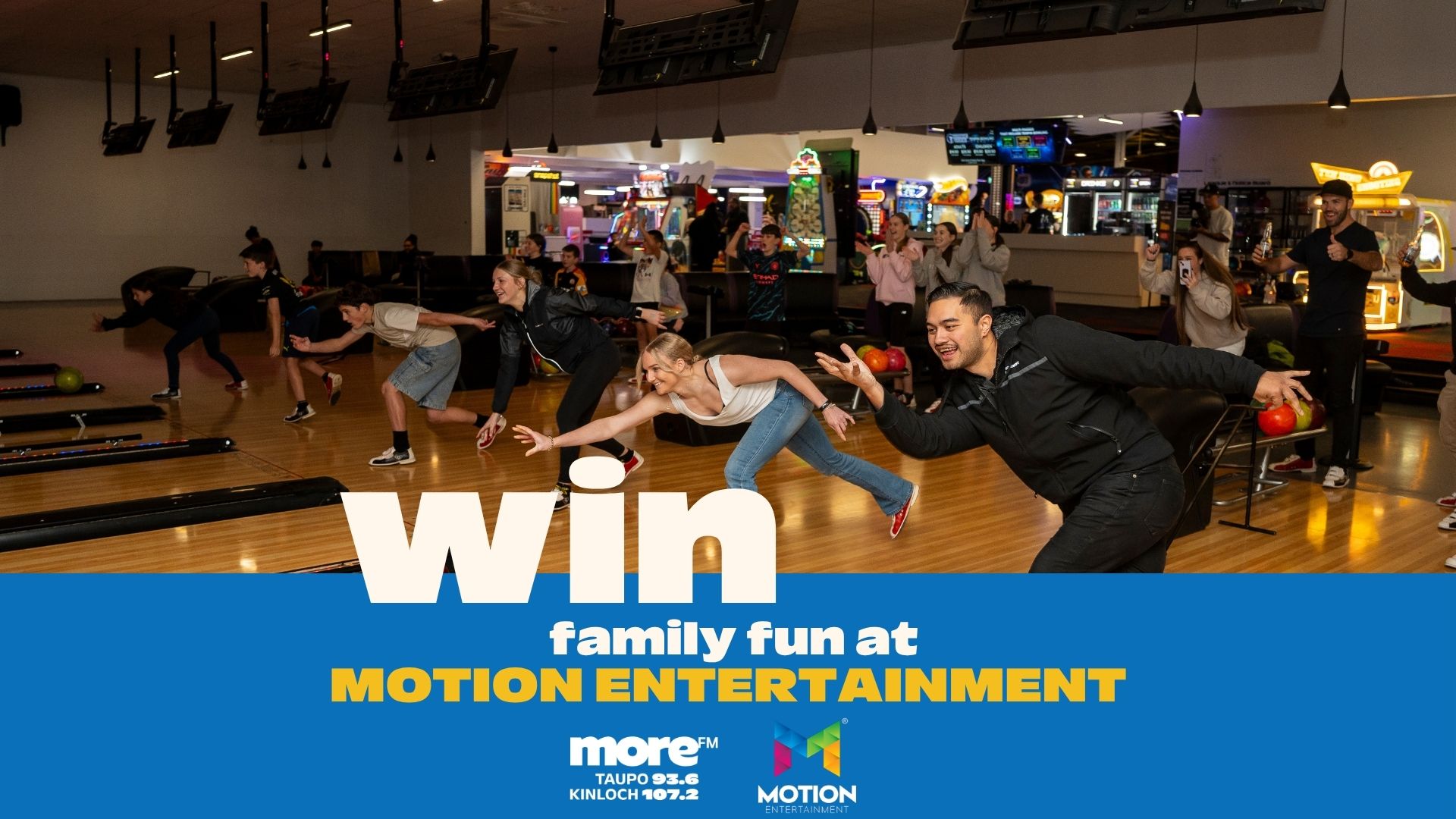A lively group of adults and children are bowling at an entertainment center, with text "Win family fun at Motion Entertainment" on a blue banner below.