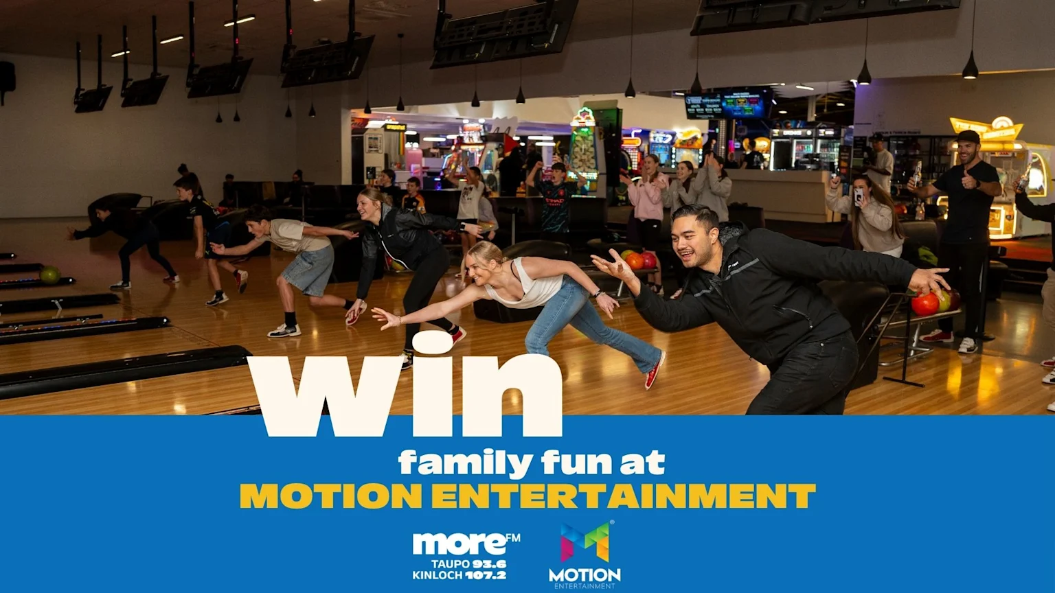 A lively group of adults and children are bowling at an entertainment center, with text "Win family fun at Motion Entertainment" on a blue banner below.