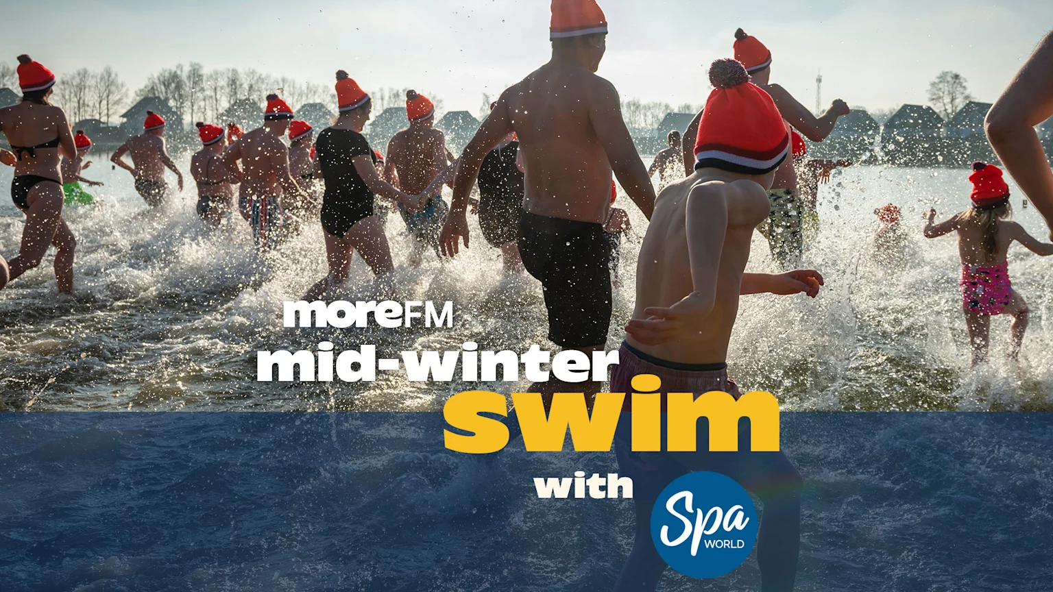A diverse group of people, many wearing orange hats, run and splash through water in a mid-winter swim event, with text overlay: "moreFM mid-winter swim with Spa World".