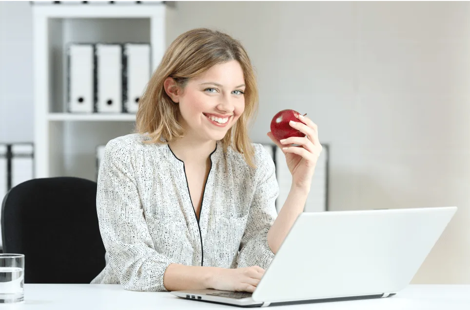 Photo of woman holding an apple for woolworths group case study