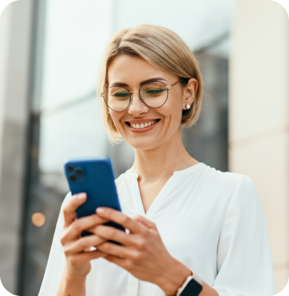 Image of a person using a mobile phone while smiling