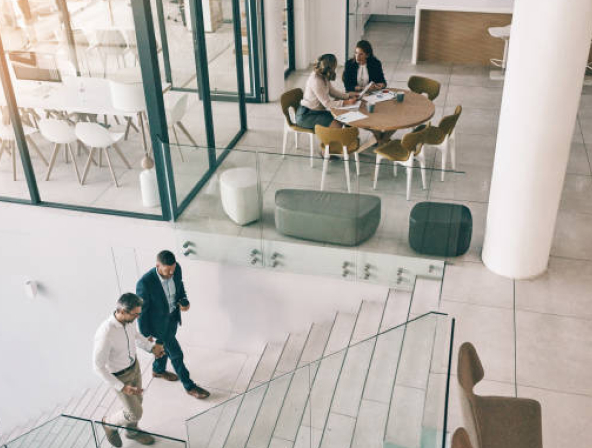 Business people walking in an office lobby.