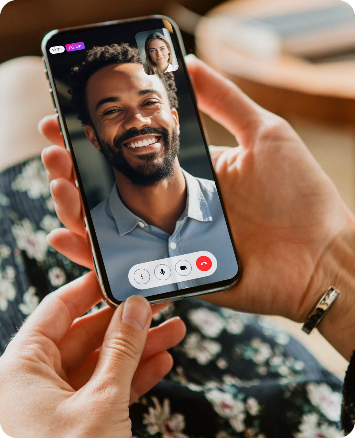 Close-up of a smartphone showing two people engaged in a Dialpad video call