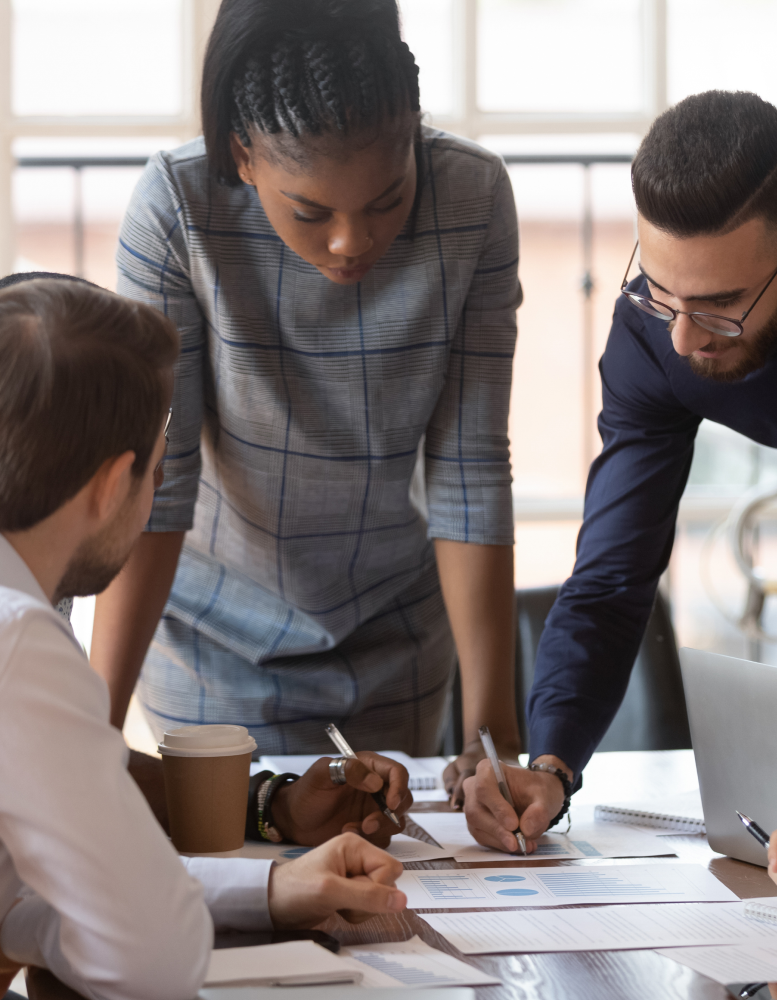 Employees discussing plans around a table