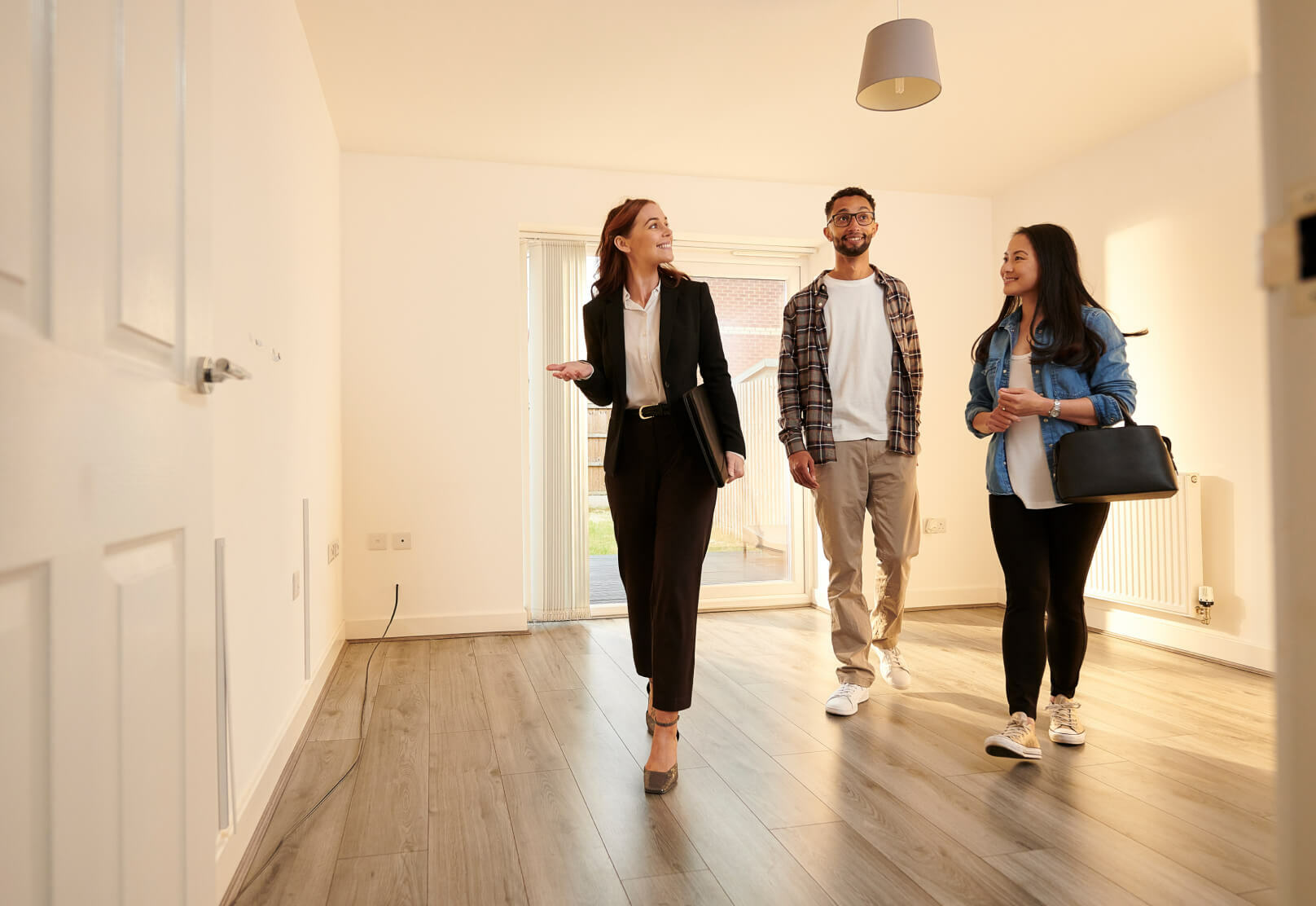 Photo of a real estate agent visiting a house with clients