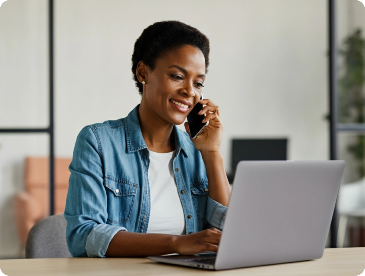 Image of a person using a laptop and cell phone to speak with a customer service agent