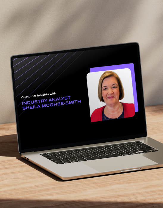 Laptop showing 'Customer Insights with Industry Analyst Sheila Mcgee Smith' slide with the speaker's image