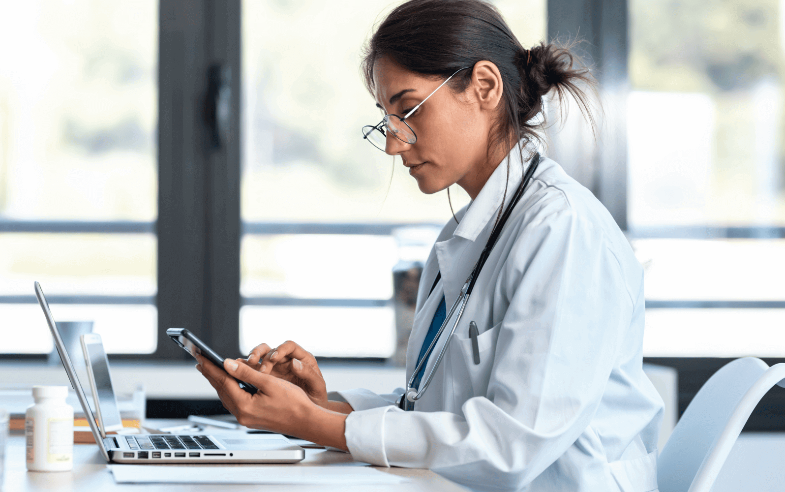 A healthcare professional using a mobile device