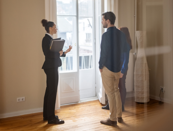 A real estate agent talking with two prospective buyers.