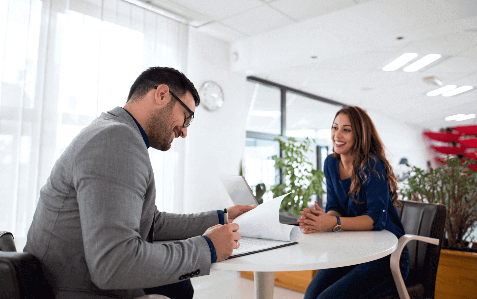 Two people sitting across from each other at an office desk