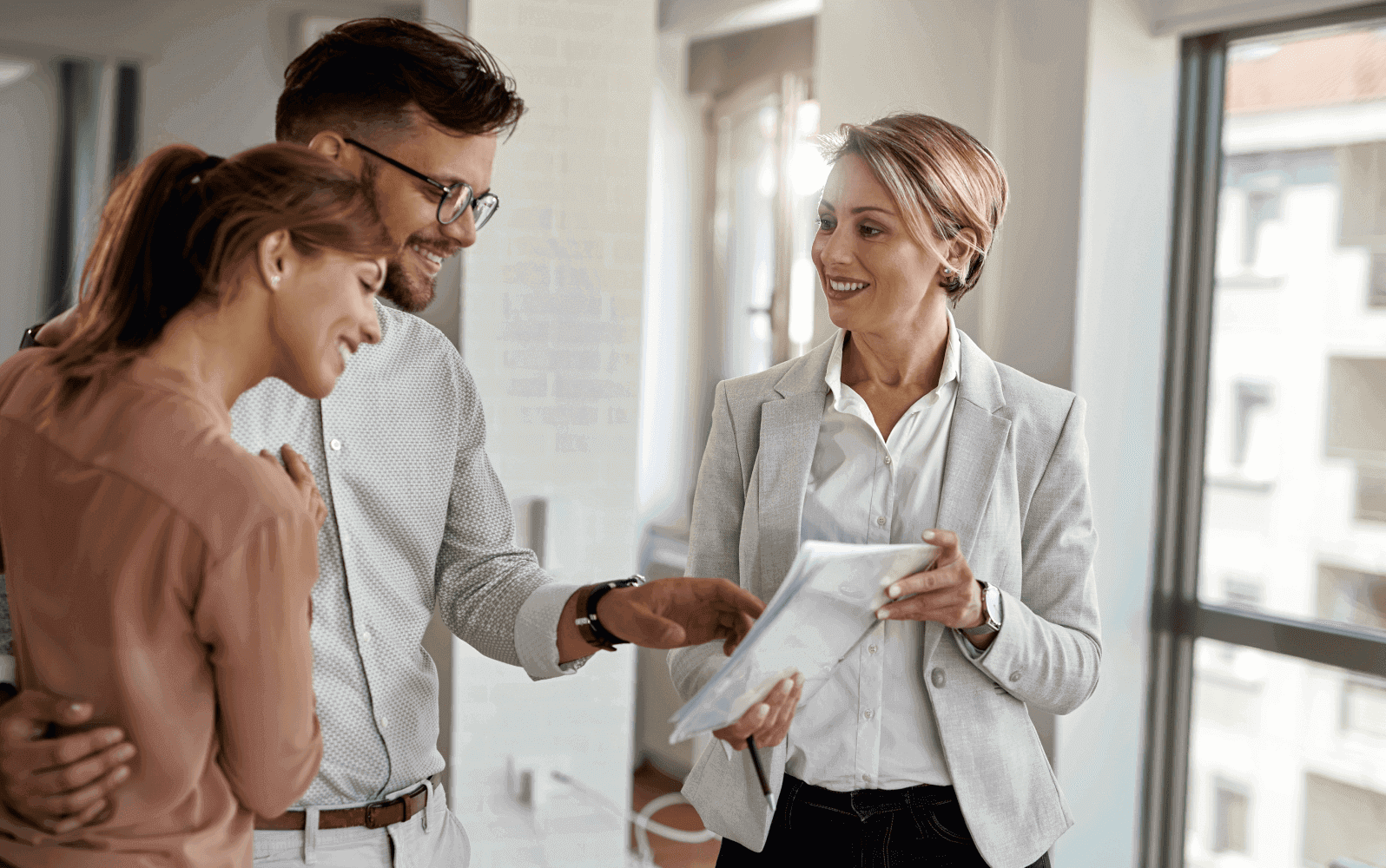 A couple speaking to a property manager at their potential new home